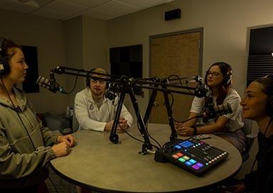 Four students doing a podcast